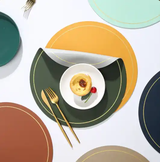 Round leather-look placemats in several colors with gold border details